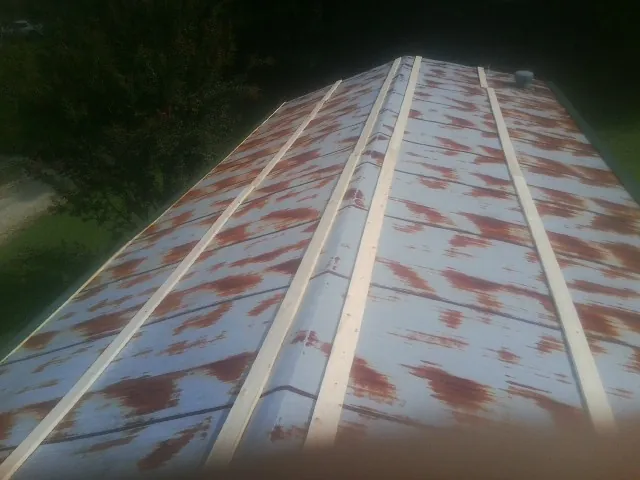 Rusted metal roof panels with new wood purlins before replacement — Storm Damage Roof Repair in Hawley by Roofing Brothers